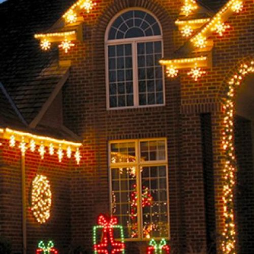 Holiday lights on a home at night.